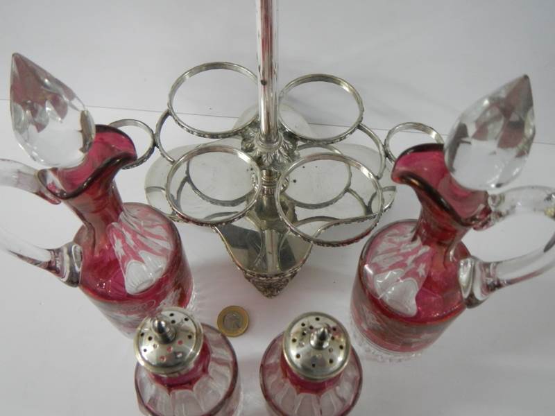 A six piece cranberry and clear glass condiment set on a plated stand. - Image 4 of 5