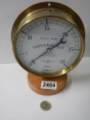 A brass cased vacuum gauge by Schaffer & Budenburg of Manchester, London and Glasgow.