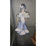 A Lladro figure of a girl with pot of flowers