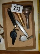 Two whistles, two pocket knives and two mouthpieces,