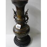 An oriental bronze vase on base.