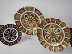 Three gilded Imari style plates.