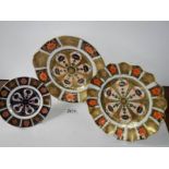 Three gilded Imari style plates.