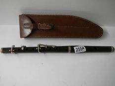 An old leather cased rosewood flute by H Porter & Co., London, complete.