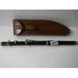 An old leather cased rosewood flute by H Porter & Co., London, complete.