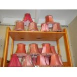 A quantity of pink lamp shades.