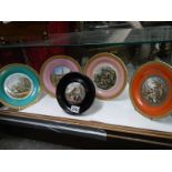 A framed Pratt ware pot lid and four Pratt ware plates.