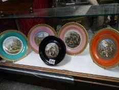 A framed Pratt ware pot lid and four Pratt ware plates.