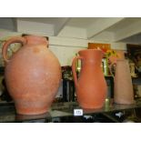 Three terracotta jugs.