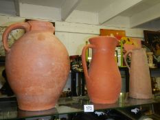 Three terracotta jugs.