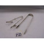 A pair of Georgian silver sugar tongs, Thomas & George Haytor 1818 & plated 1920's asparagus tongs.