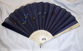 A fabric fan with hand painted birds