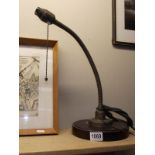 A vintage brass flexible neck table lamp on mahogany base