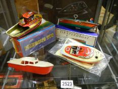Two boxed tin plate boats and two unboxed.
