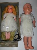 An old boxed wax doll and another old doll (missing wig).
