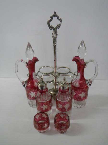 A six piece cranberry and clear glass condiment set on a plated stand. - Image 3 of 5