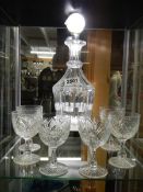 A cut glass decanter and six glasses.