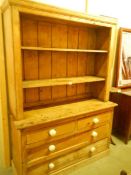 An antique pine drawer base dresser with open rack, COLLECT ONLY.