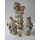 Two bisque porcelain busts and a figure.