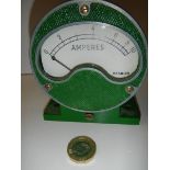 A vintage ammeter mounted in a cast metal housing.
