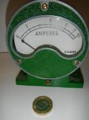 A vintage ammeter mounted in a cast metal housing.