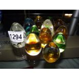 A quantity of coloured glass paperweights