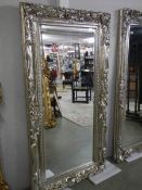 A large bevel edged mirror in gilded double swept frame, 92 x 176 cm. COLLECT ONLY.