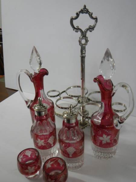 A six piece cranberry and clear glass condiment set on a plated stand. - Image 5 of 5