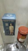 A Doctor Who Tardis tin and a red pillar box money bank.