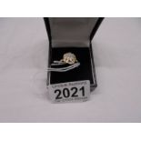 An all over diamond swirl ring in white/yellow gold, size P. 2.1 grams.