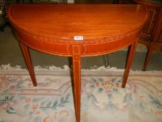 A mahogany D shaped games table. COLLECT ONLY.