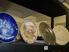 Two collector's plates, a metal plate and a Madonna with child plaque.