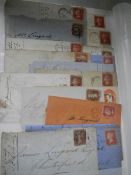 An album of penny red and other stamps including stamped envelopes.