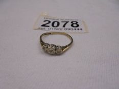 A 9ct gold three stone ring, size M, 1.2 grams.