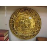 A large pressed brass wall plaque depicting sailing ship diameter 55cm COLLECT ONLY