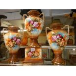 A set of three early 20th century floral decorated vases, (one on a pedestal). COLLECT ONLY.