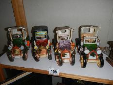 Four ceramic vintage cars.