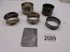 Four silver napkin rings (70 grams) and two other items.