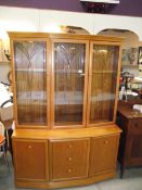 A golden oak wall unit with cut glass doors, COLLECT ONLY.