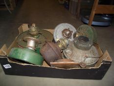 A box of vintage greenhouse oil lamp heaters, some with Duplex burners