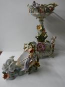 A porcelain comport featuring cherubs and two other items with swans and female figures.