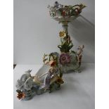 A porcelain comport featuring cherubs and two other items with swans and female figures.