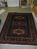 A vintage Persian red wool rug, Approximately 128 x 178 cm, COLLECT ONLY.
