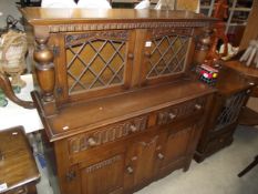 A 1930's oak sideboard with leaded glass doors COLLECT ONLY