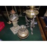 2 wrought iron framed oil lamps with brass fonts and 1 other