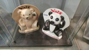Two Wade collectables signs, a bear and a panda.