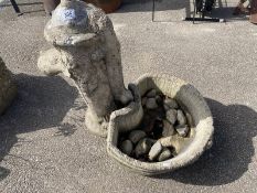 A garden ornament in the shape of a water pump and base