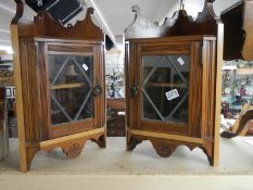 A pair of small mahogany corner cabinets with leaded glass doors,. COLLECT ONLY.