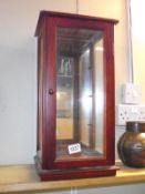 A table top mahogany display cabinet (no shelves) would maybe suit a doll. 26.5cm x 22.5cm, height