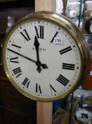 A brass faced Magneta Pulsynetic wall clock for use with a master clock.